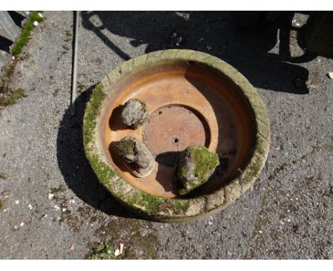 A circular stone garden planter & three small stone animals (outside)