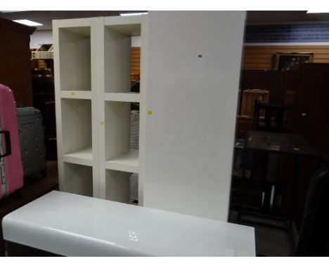 A pair of tall narrow shelving units, a tall narrow cupboard with a three-drawer base together with a white perspex & chrome 