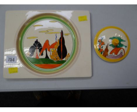 A Clarice Cliff plate decorated later together with a lidcondition:The plate is 21 x 26cms, good condition, no chips or damag