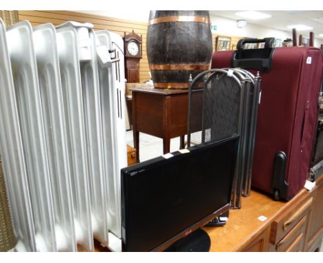 Parcel of items to include a small LG TV, Dimplex storage heater, fireguard & suitcase E/T