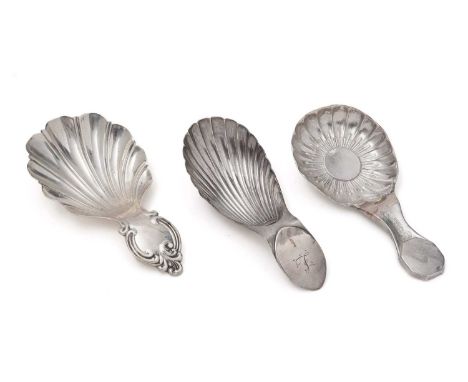 Three antique silver, Sheffield-made caddy spoons, to include:- one with the bowl resembling an anemone flower by Thomas Law,