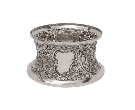 An Edwardian Irish silver dish ring in the rococo style italics with concave sides, pierced and embossed with flowers, fruit,