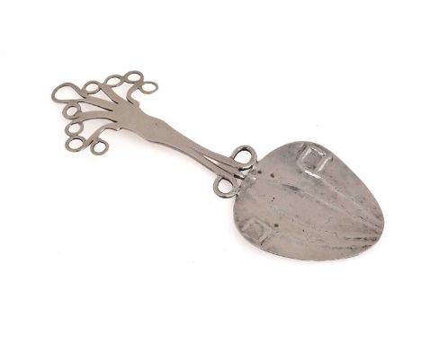 An arts and crafts silver spoon (perhaps a large caddy spoon) with a chased, spade-shaped bowl and a pierced scrollwork stem 