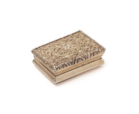 A George IV silver gilt vinaigrette, rectangular with a chased design on the cover, concave sides, an engine-turned base and 