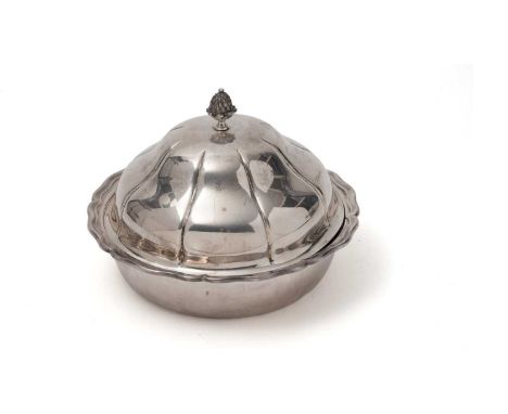 A George V silver muffin dish and cover of shaped circular outline with a drop-in liner and bud finial, by C.S. Green &amp; C