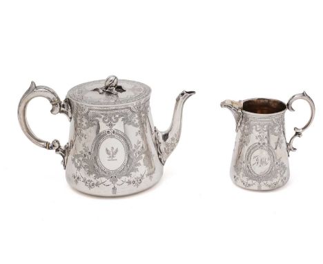 A Victorian engraved silver teapot and matching cream jug with flat bases and c-scroll handles, the teapot with a concealed f