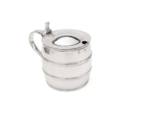 A George III silver mustard pot in the form of a barrel, with reeded hoops, a low-domed cover, crested, and a reeded scroll h