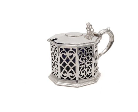 An early Victorian silver mustard pot, octagonal with fret-pierced panels of pierced scrollwork around the sides, pierced thu