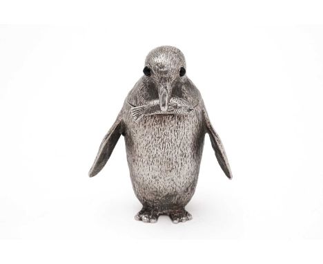 An Elizabeth II cast silver mustard pot in the form of a penguin, with dark glass eyes and matching spoon with a fish termina
