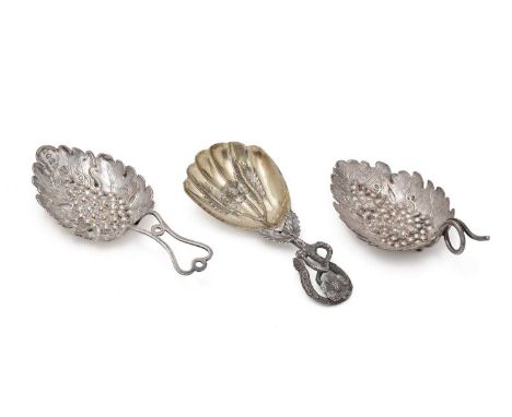 A George III silver caddy spoon, with vine leaf and grapes and a coiled wire handle by Joseph Wilmore, Birmingham 1807, anoth