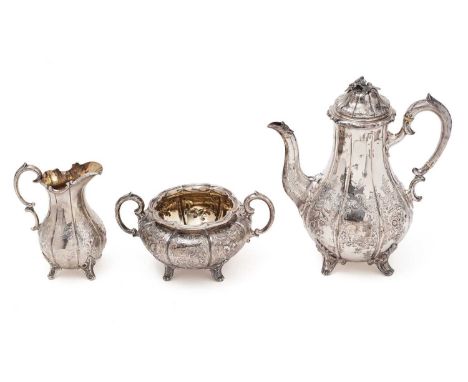 A Victorian silver three-piece coffee set with fluted baluster bodies, decorated with repoussé-work floral sprays and scrollw