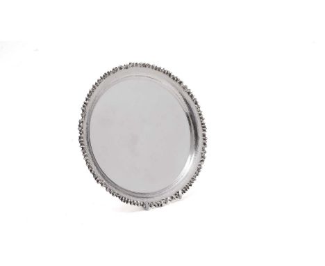 An Elizabeth II silver salver, circular with a convex textured border and an applied cast rim, by Christopher N. Lawrence, Lo