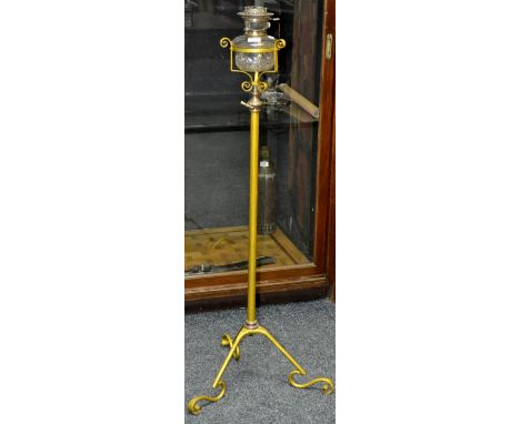A Victorian wrought iron standard oil lamp, with telescopic action, clear glass reservoir, painted gold, circa 1880.