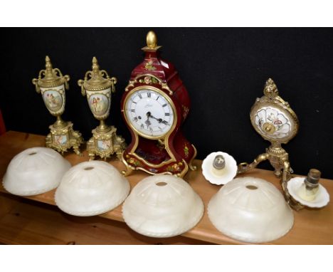 A clear glass pedestal bon-bon dish; another smaller; a decorative three piece clock garniture; light fittings; vases; candle