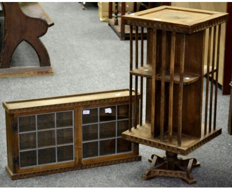 An early 19th century oak revolving library bookcase; a similar small oak glazed wall shelf unit (2)