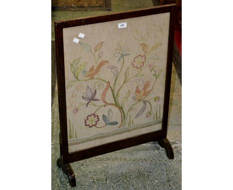 An oak framed needlework firescreen.