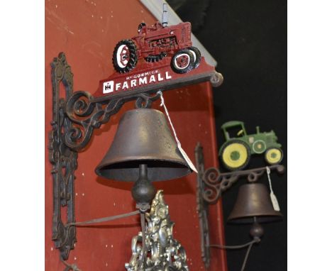 Two cast iron tractor bells.
