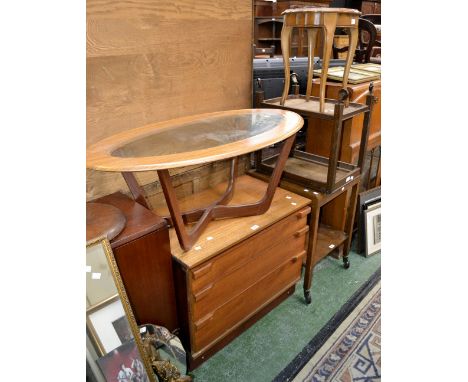 A 1960's teak standard lamp; an oval glass inlaid coffee table; a teak three drawer chest; two tea trolleys; an occasional ta