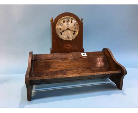 A mahogany mantle clock and a book slide