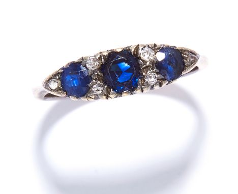 A SAPPHIRE AND DIAMOND DRESS RING in yellow gold, set with three round cut sapphires and alternating round cut diamonds, unma