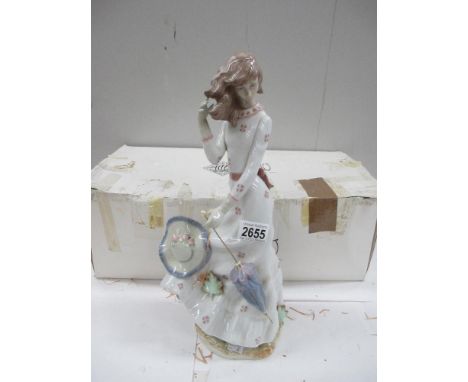 A large NAO figure of a Lady with Umbrella and Hat on a windy day (with box)