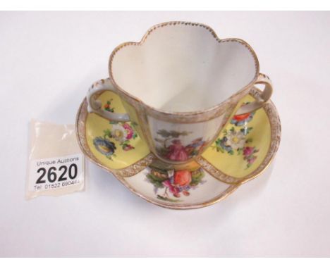 A Meissen two handled cup and saucer painted with courting couples