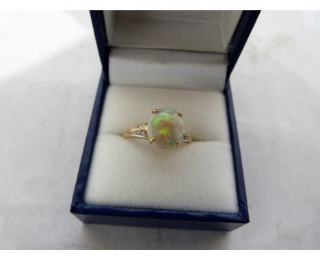 An opal and white stone ring. In gold marked 9k. Size R. 2.2g gross