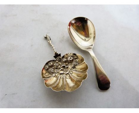 A silver caddy spoon with shell bowl and a plated example