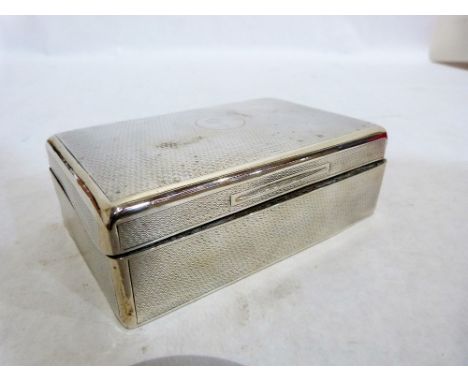 A George V engine turned silver cigarette box, cedar lined. 5½'' wide. London 1923