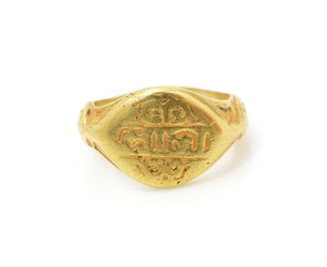 An antique gold signet ring, the main plaque with script, possibly Hebrew, with shaped shank, tests as 22-24ct gold, ring siz