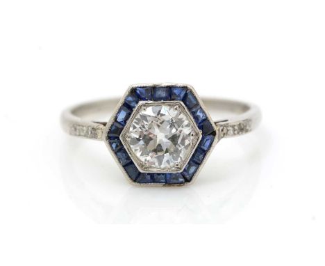 An Edwardian sapphire and diamond ring, the central old-cut diamond weighing approximately 0.75carats, within a shaped step-c