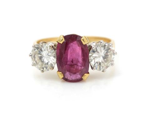 A ruby and diamond ring, the oval facet cut ruby measuring 11.3 x 7.5 x 3.5mm estimated to weigh 2.16carats, flanked by brill