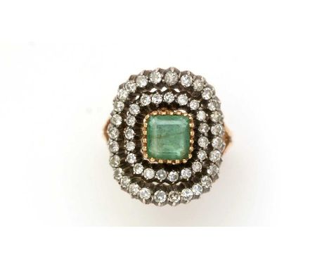 An emerald and diamond cluster ring, the central square step-cut emerald within a double cluster of eight-cut diamonds, in 80