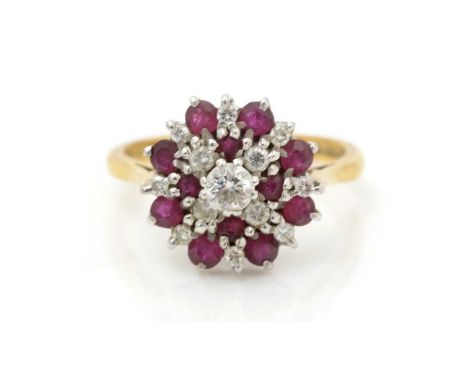 A ruby and diamond cluster ring, set with twelve circular facet cut rubies and thirteen brilliant cut diamonds, in 18ct white