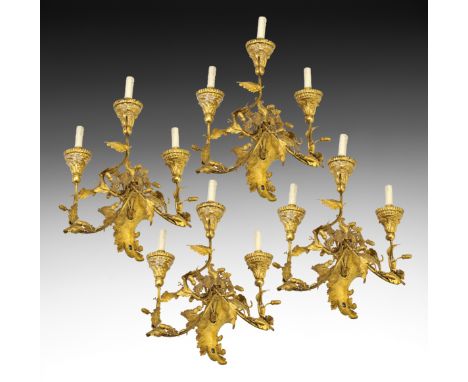 Quattro appliques in metallo e tolla dorata a tre luci, XIX secolo Four 3-light golden tin and metal wall lights, 19th centur