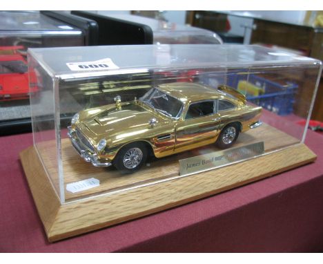 A Danbury Mint 1:24th Scale Gold Plated Finish James Bond Aston Martin DB5, presented on a plinth within a perspex case, no b