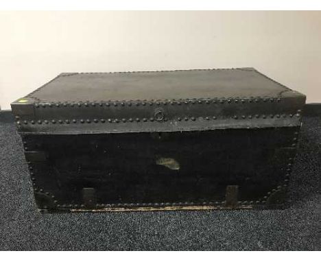 An antique leather bound trunk with metal mounts 