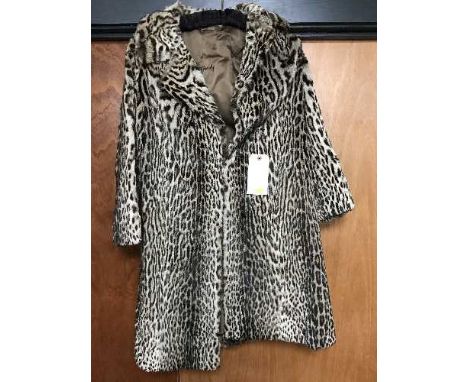 A vintage lady's ocelot fur coat retailed by Harrods of London 