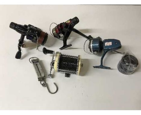 A box of three spinning reels, one sea fishing reel and a set of pocket scales 