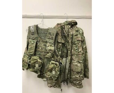 A very large quantity of British Army clothing, jackets, trousers, protective hard hats, vest tops etc.