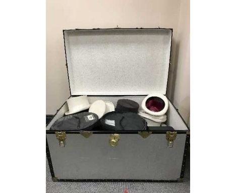 A metal trunk of top hats 