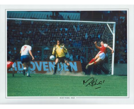 Football Mickey Thomas signed 16x12 colour print pictured scoring for Wales against England. Good condition. All autographs c