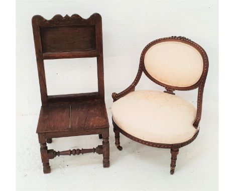 LATE VICTORIAN NURSING CHAIRwith an oval padded back above an oval stuffover seat, standing on turned front supports with por