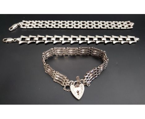 THREE SILVER BRACELETSone a gate bracelet with heart padlock clasp; the other two of heavy flat link design, total weight app