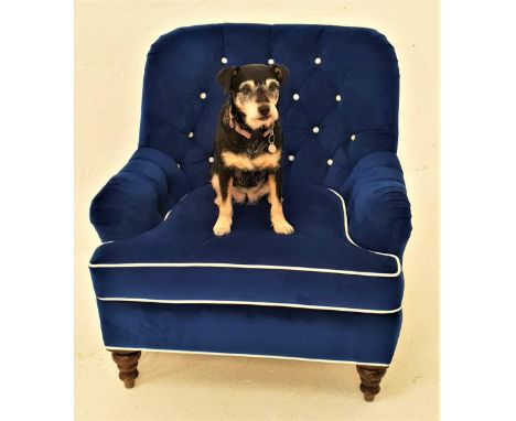 LATE VICTORIAN ARMCHAIRwith a shaped button back and stuffover shaped seat cushion, upholstered in a Royal blue velvet with c