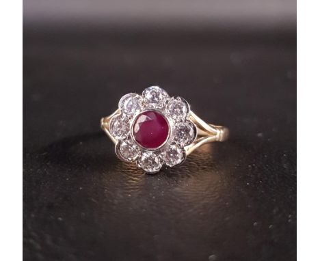 RUBY AND DIAMOND CLUSTER RINGthe central round cut ruby approximately 0.45cts, in eight diamond surround totaling approximate