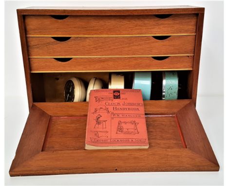 MAHOGANY WATCH REPAIRERS CABINETwith a fold down front revealing three drawers with an assortment of digital and mechanical w