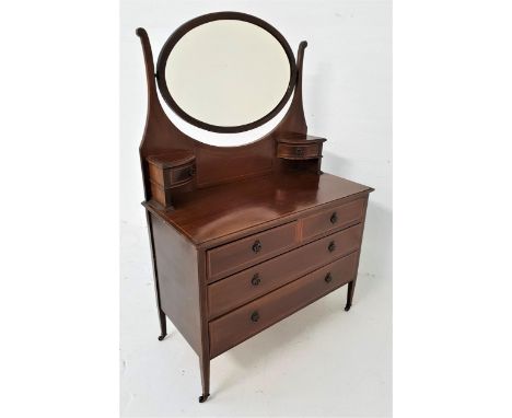 EDWARDIAN MAHOGANY AND INLAID DRESSING CHESTwith an oval mirror back above two shaped jewellery drawers, the base with two sh