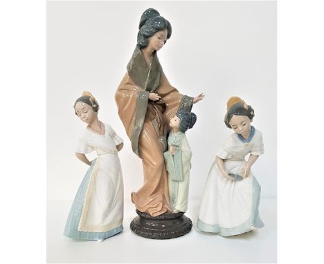 THREE NAO FIGURINESdepicting a Japanese mother and her daughter, 38cm high, and two young girls, 24cm and 26cm high (3) 