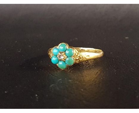 VICTORIAN DIAMOND AND TURQUOISE CLUSTER RINGthe central diamond chip surrounded by six cabochon turquoise stones, on eighteen